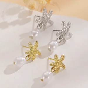 Detailed close-up of starfish-shaped earrings with irregular pearls in gold and silver