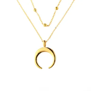 Double layered gold necklace featuring crescent moon pendant and delicate beads design