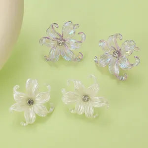 Detailed macro view of Y2K acrylic iris flower earrings in purple and white pearls