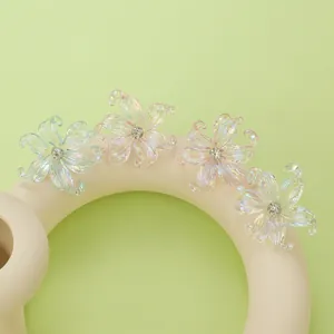Macro shot of y2k iris earrings with iridescent resin petals and crystal center