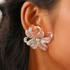 Macro view of iridescent Y2K iris flower earrings with a sparkling zircon center
