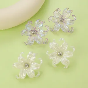 Detailed macro view of colorful y2k floral earrings with central diamonds and resin petals