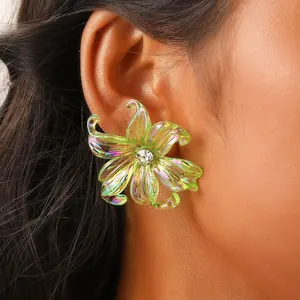 Close-up of a model wearing a green Y2K floral earring with iridescent resin petals