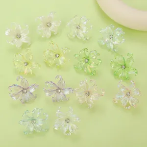 Macro shot of colorful pearlescent y2k flower charms with rhinestones on light green background