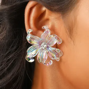 Close-up of Y2K iridescent resin iris flower earrings with sparkling rhinestone center