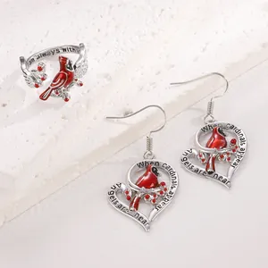 Detailed view of red cardinal bird jewelry set with sentimental text engravings