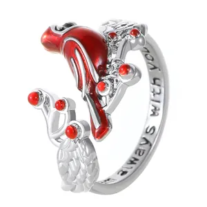 Detail view of silver cardinal ring with red enamel and 'I am always with you' engraving