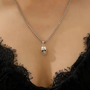 Gothic skull pendant necklace in silver finish with vintage punk style on model
