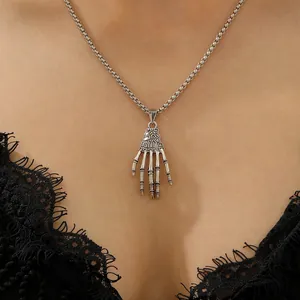 Gothic silver skull hand pendant necklace with punk skeleton hand on a vintage chain