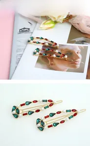 Detail of luxury gold alloy hair clip with red and green crystals and white pearls