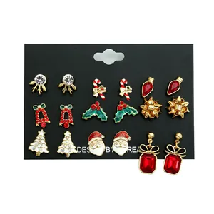 9-pair Christmas earring set with reindeer, Santa, and tree designs on a black card
