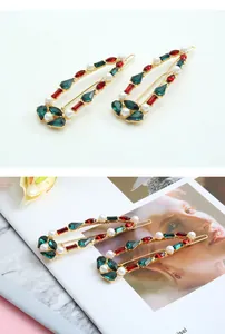 Detail of vintage gold alloy hair clips with colorful rhinestones and white pearls