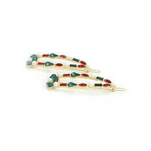 Elegant gold-tone crystal and pearl hair clips set with colorful rhinestones on white background