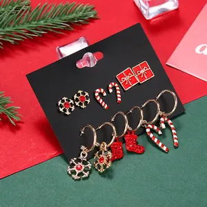 6-piece Christmas earring set with snowflake and candy cane charms on festive background