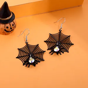 Halloween black spider web hook earrings with colorful rhinestones on orange background