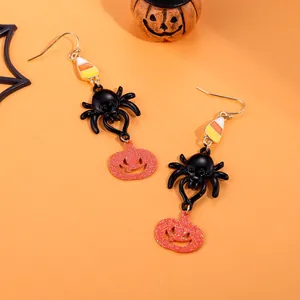 Halloween drop earrings with black spider and orange glitter pumpkin charms on hook