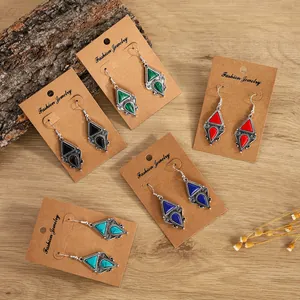 Detail of bohemian silver-plated earrings set with vintage turquoise resin in five colors