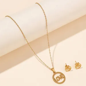 Detail of gold titanium steel necklace and earrings set featuring cutout LOVE pendants