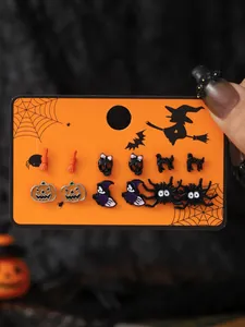 Set of 6 pairs of Halloween themed stud earrings featuring pumpkin and spider icons