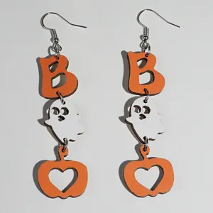Detail of Halloween drop earrings featuring orange pumpkin, white ghost and letter B