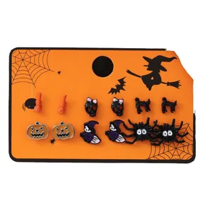 Set of 6 Halloween stud earrings featuring pumpkin, ghost, and spider motifs on orange card