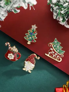 Close-up of Christmas brooches set featuring tree and sleigh with rhinestones