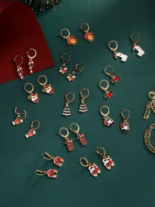Close-up of festive Christmas earring set with snowman, reindeer and snowflake charms