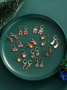 Flat lay of colorful Christmas earrings set including reindeer and snowflake motifs