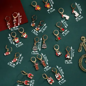 Christmas earring set with festive Santa, snowflake, and reindeer charms on green background