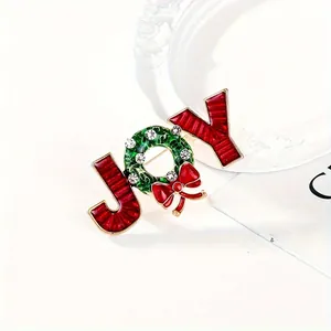 Broche de Noël JOY avec lettres à rayures rouges, couronne verte et nœud brillant