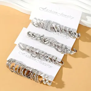 24-piece set of silver-toned geometric earrings and pearl studs on white cards