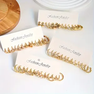 Detail of vintage gold earring set featuring geometric shapes and pearls on card