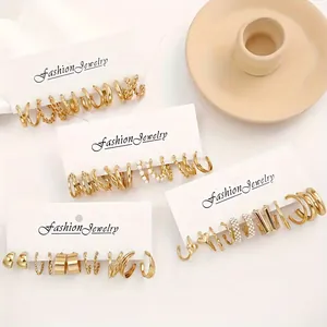 Detailed set of vintage gold earrings with geometric textures and faux pearl accents