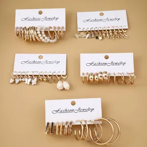 Detail of 24-piece vintage gold earring set with pearls and geometric charms