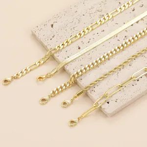 Set of five bohemian gold-tone bracelets featuring figaro and snake chain styles