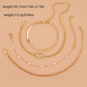 Set of four gold bohemian bracelets featuring snake chain and butterfly pendant charms