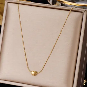 Minimalist gold heart necklace for women in elegant jewelry box, polished steel finish