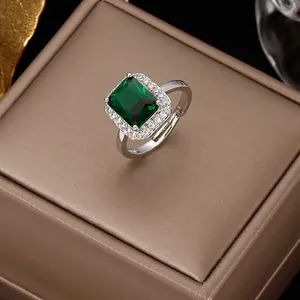 Vintage emerald cut green zircon ring with silver halo setting on a jewelry box