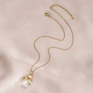 Golden Teru Teru Bozu angel necklace with a large crystal pendant on champagne silk fabric