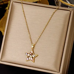 Gold star pendant necklace with colorful zircons on a champagne jewelry display box