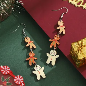 Christmas gingerbread man drop earrings in three-tone brown hanging from silver hooks