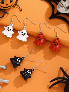 Three pairs of colorful ghost dangle earrings for Halloween set against an orange background