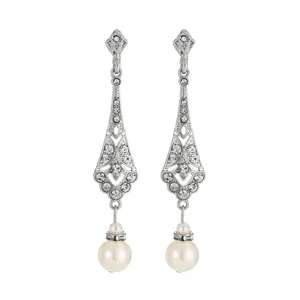 Close-up of vintage teardrop earrings with crystals and white pearls on white background