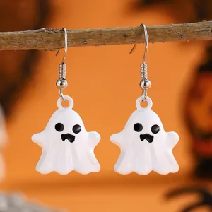 Cute white cartoon ghost drop earrings on wood branch with orange Halloween background
