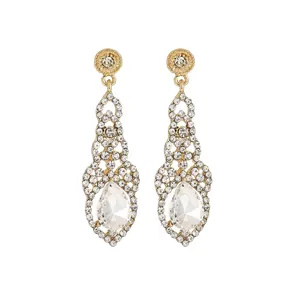 Macro detail of gold vintage pear-cut teardrop earrings with shimmering crystal accents