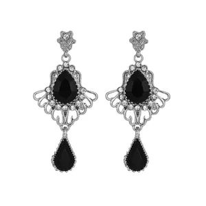 Detail of silver drop earrings with black gemstone and sparkling rhinestones
