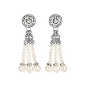 Detail of vintage teardrop tassel earrings with white pearls and sparkling crystals