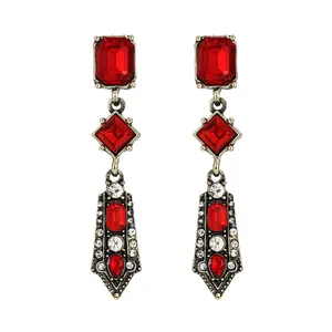 Vintage gold drop earrings with large red gemstones and shimmering crystal accents