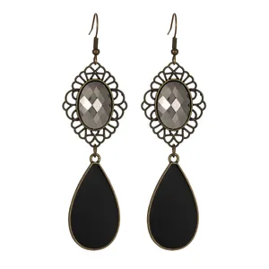 Detail shot of vintage bronze waterdrop earrings with grey gemstone and black pendants
