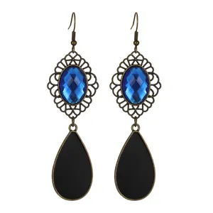 Detailed close-up of retro hollow lace bronze earrings with blue gem and black drop